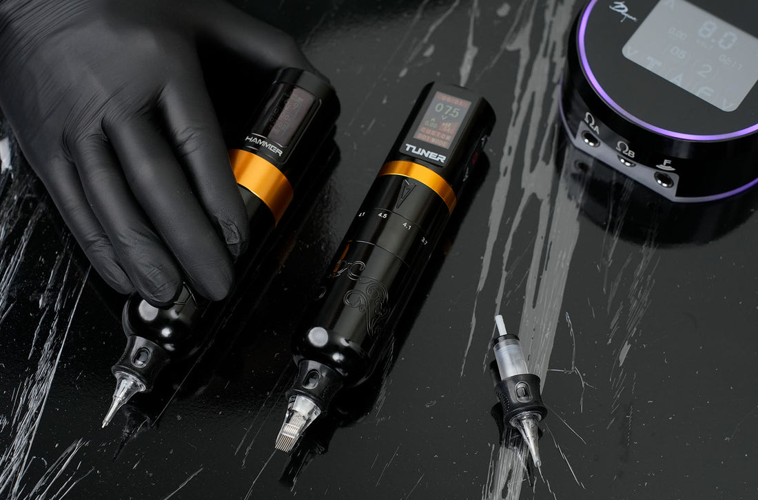Tattoo artist in black gloves comparing Dragoart Hammer and Tuner rotary tattoo machines with digital displays, cartridge needle, and power supply on workstation