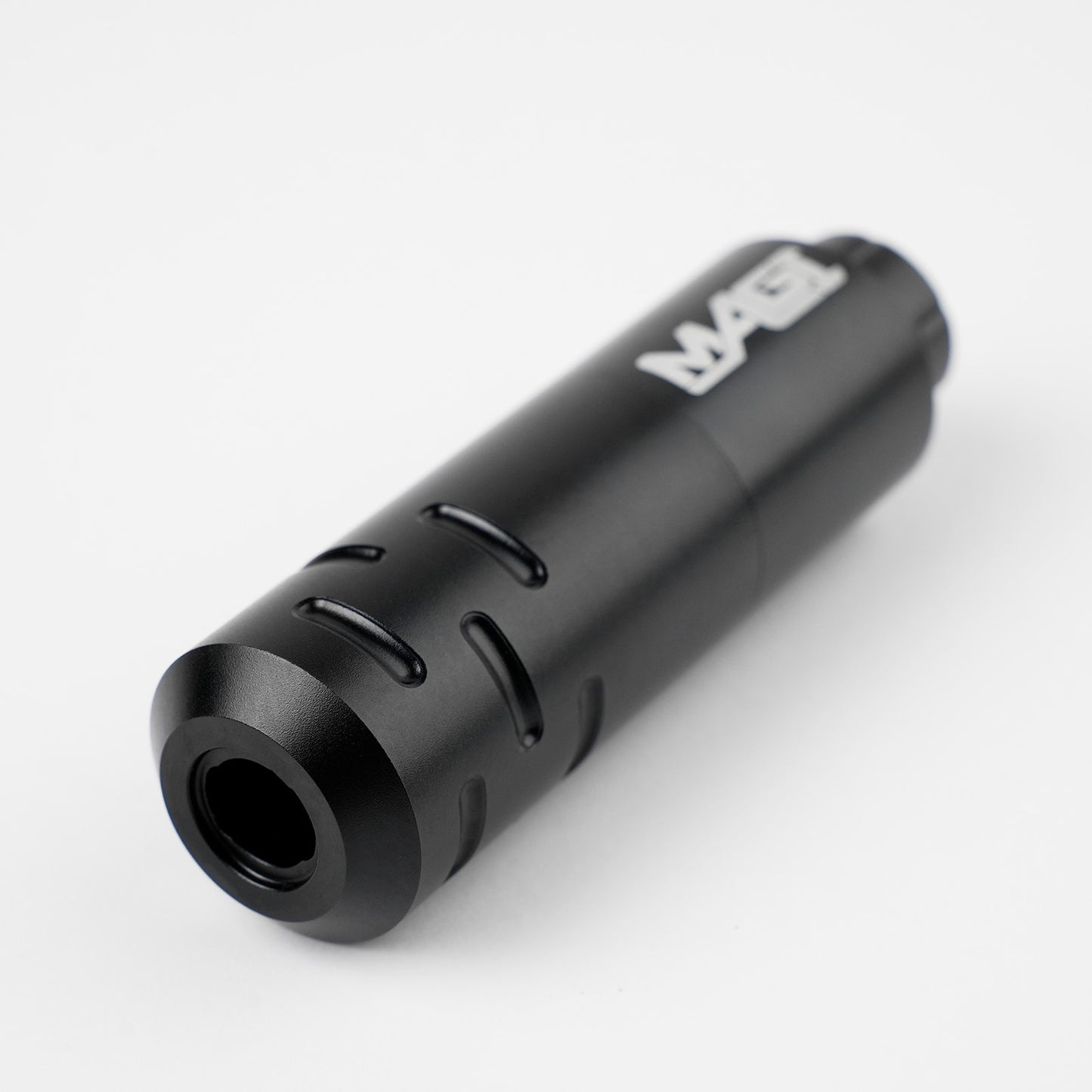 Close-up of black MAGI rotary tattoo pen machine with ergonomic grip design, lightweight body, and professional tattoo equipment build.