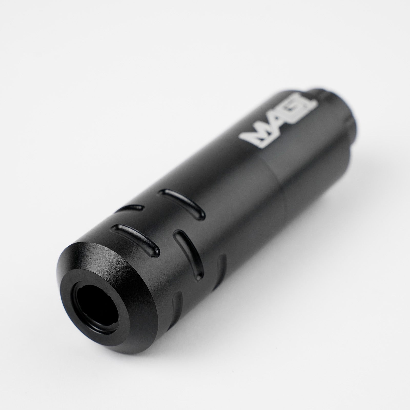 Close-up of black MAGI rotary tattoo pen machine with ergonomic grip design, lightweight body, and professional tattoo equipment build.