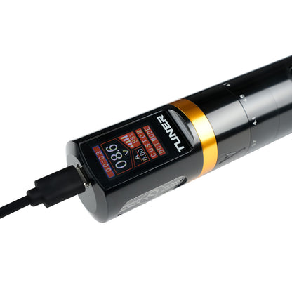 Dragoart Tuner black wireless tattoo machine charging with digital display showing voltage and dot mode.