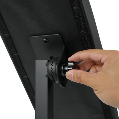 Adjusting the tilt angle of a tattoo arm rest cushion using the locking knob on adjustable armrest stand.