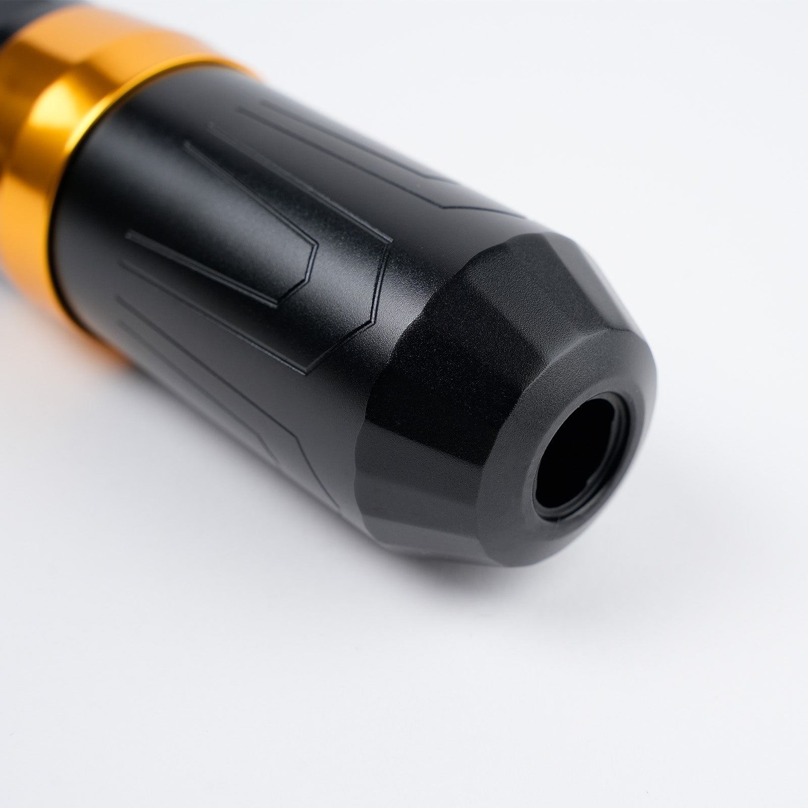 Close-up of Dragoart Archer II tattoo pen ergonomic textured grip and cartridge port with gold accent ring